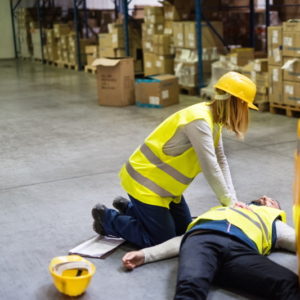 An accident in a warehouse. Woman performing cardiopulmonary resuscitation.